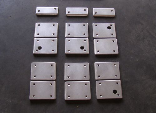 Cradle Ring Hinge Plates being shaped on a bench grinder.